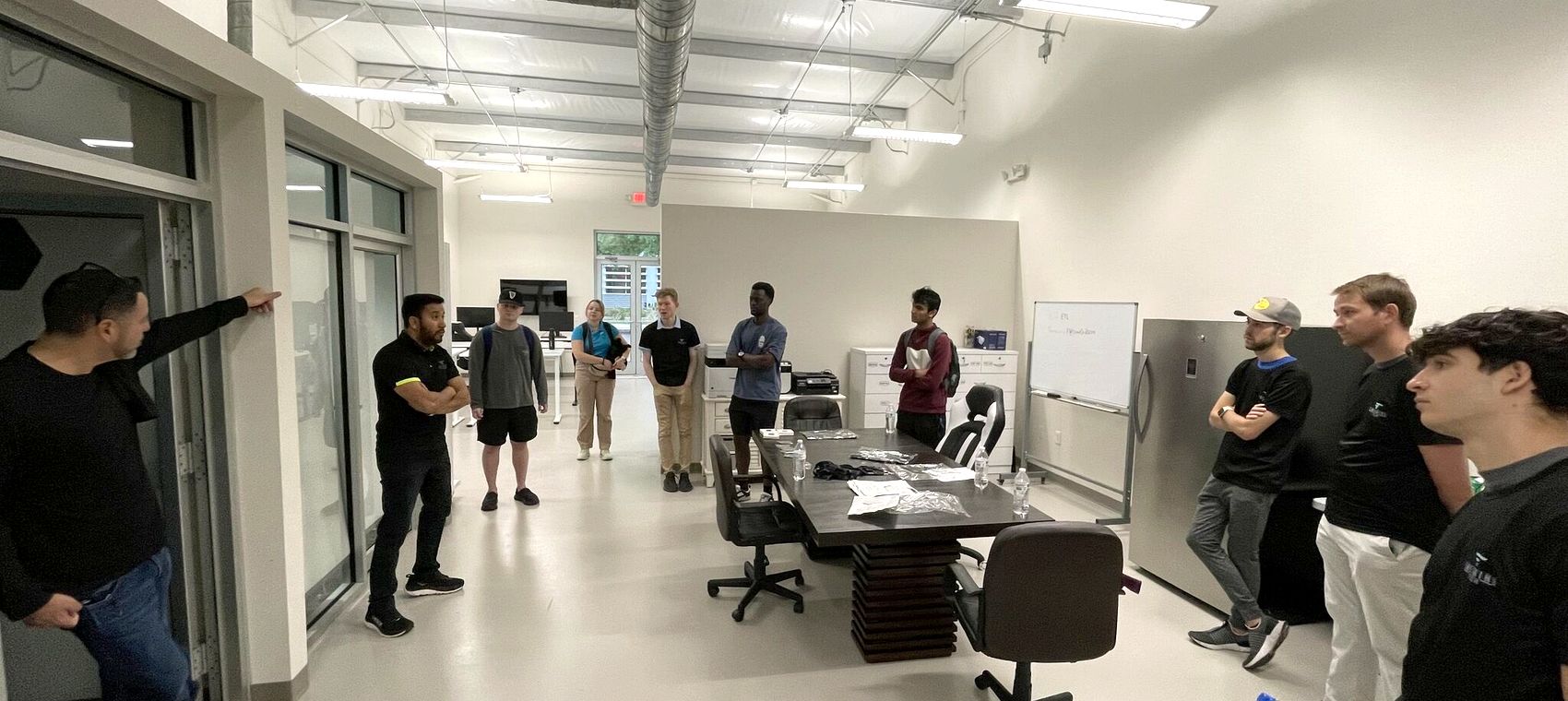 Emerging Tech staff and interns gathered in the open office at the Alachua headquarters